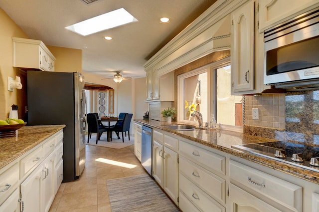 bathroom with tile patterned flooring, ceiling fan with notable chandelier, double vanity, and a textured ceiling