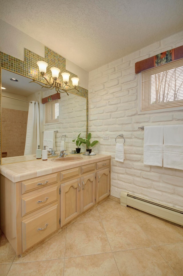 bathroom featuring a notable chandelier, vanity, a baseboard heating unit, a textured ceiling, and tile patterned flooring