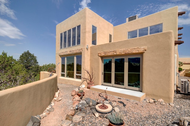 rear view of house featuring central AC unit