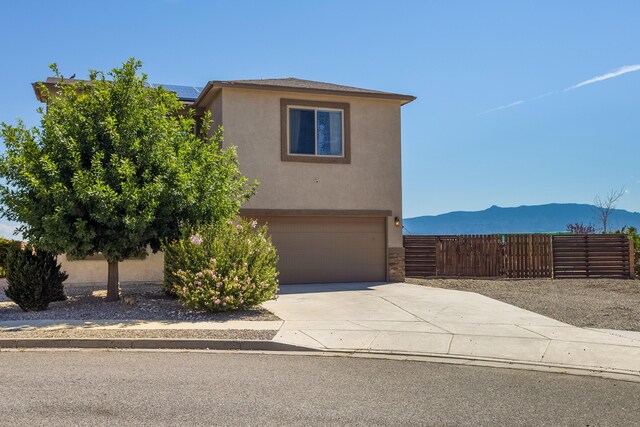 view of front of house with a mountain view and a garage