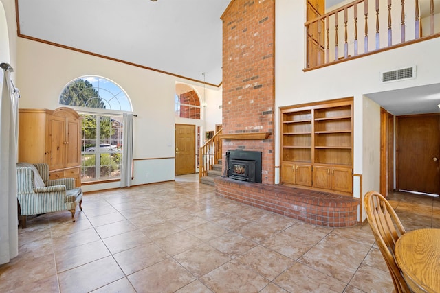 tiled living room featuring ornamental molding and a towering ceiling