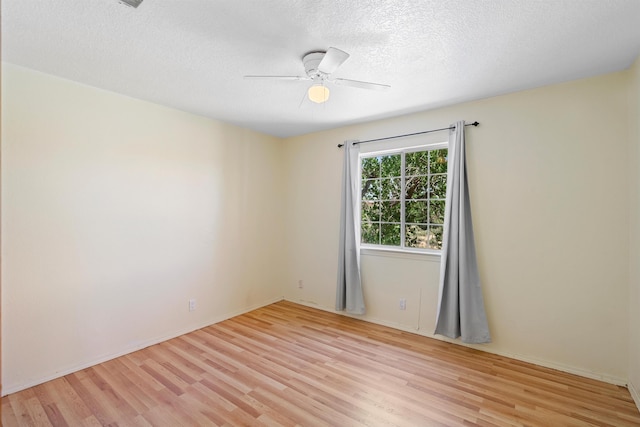 unfurnished room with light hardwood / wood-style flooring, ceiling fan, and a textured ceiling