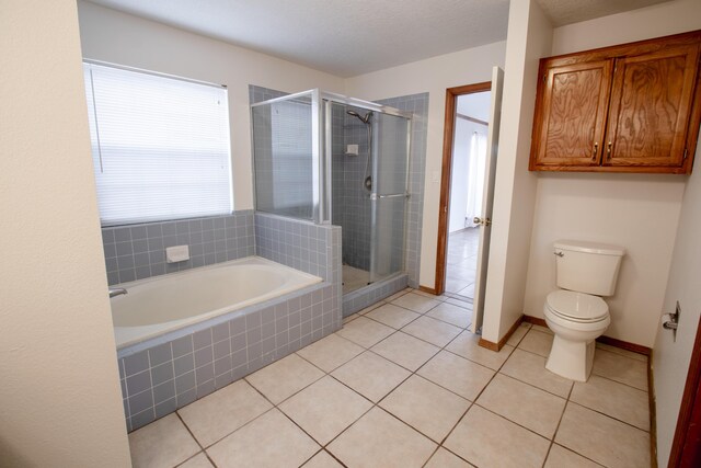 bathroom featuring tile patterned flooring, shower with separate bathtub, and toilet