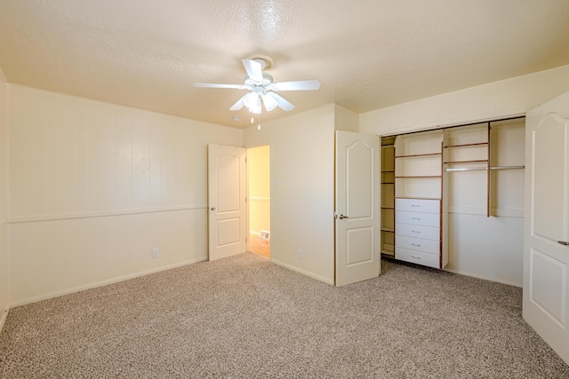 unfurnished bedroom featuring ceiling fan, carpet, a closet, and a textured ceiling