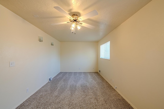 unfurnished room with carpet, ceiling fan, and a textured ceiling