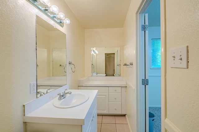 bathroom with tile patterned floors and vanity