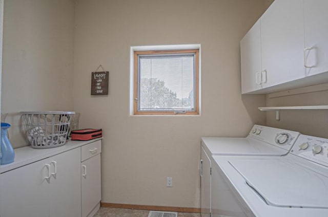 clothes washing area featuring cabinets, washing machine and dryer, and light tile patterned floors
