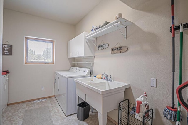 laundry room featuring cabinets, sink, light tile patterned flooring, and washing machine and dryer