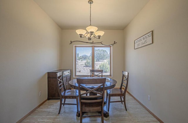 dining room with an inviting chandelier and wood-type flooring