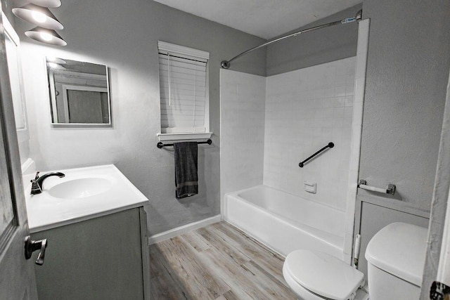 full bathroom featuring bathtub / shower combination, vanity, toilet, and hardwood / wood-style floors