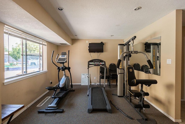 exercise room with a textured ceiling