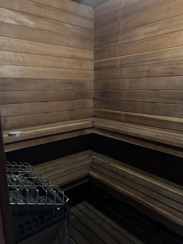 view of sauna / steam room featuring wooden walls