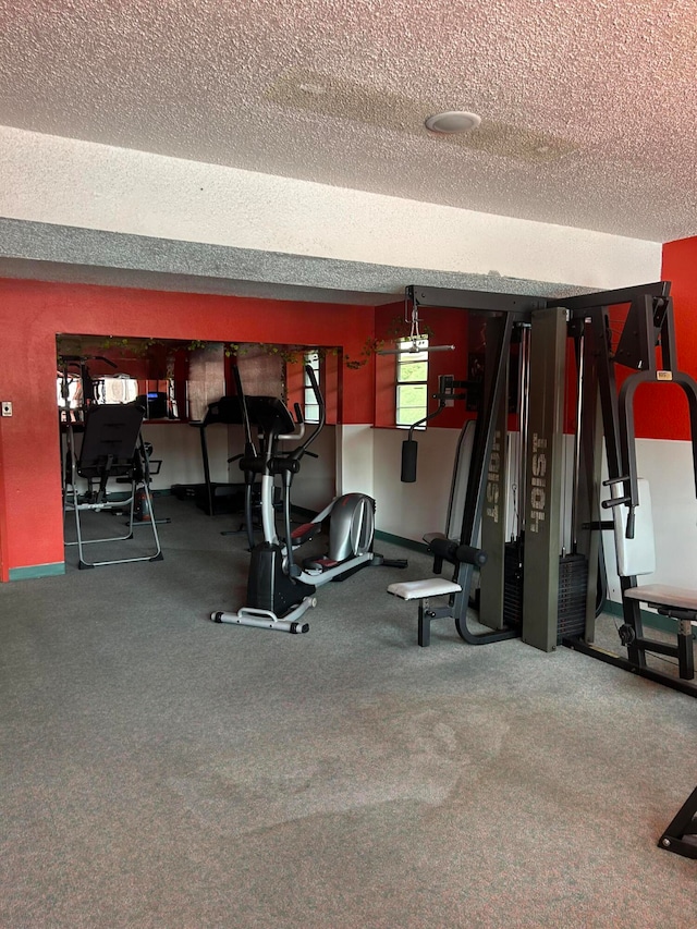 gym with carpet floors and a textured ceiling