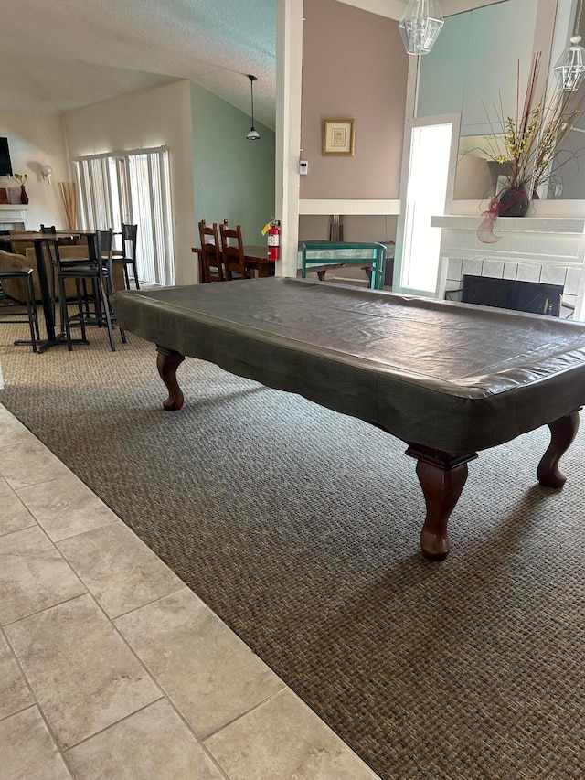 game room with vaulted ceiling, a textured ceiling, tile patterned flooring, and pool table