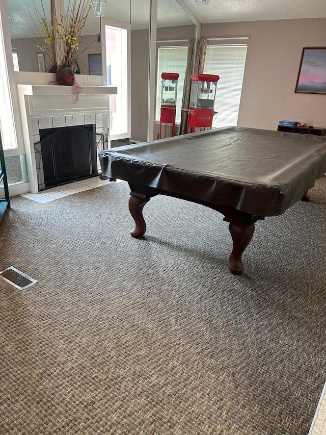 playroom with a fireplace, carpet flooring, pool table, and a textured ceiling