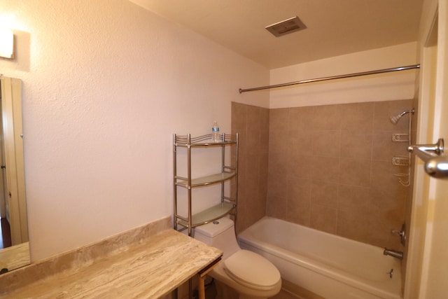 bathroom with toilet and tiled shower / bath combo