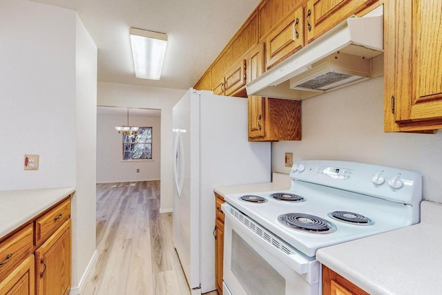 kitchen with electric stove, light hardwood / wood-style flooring, and a notable chandelier