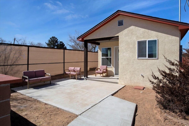 rear view of house featuring a patio area and outdoor lounge area