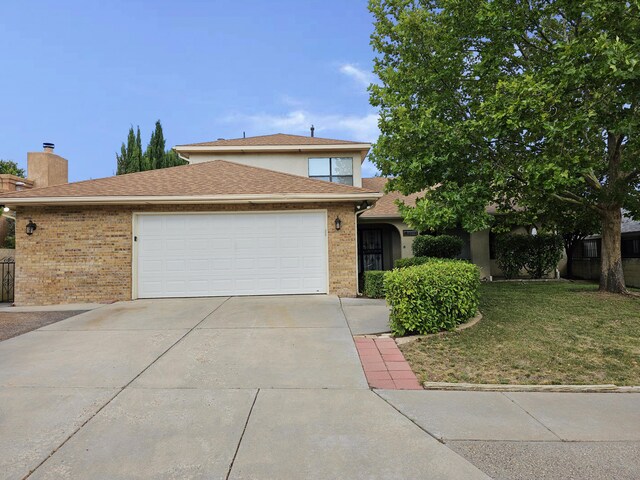 view of front of house featuring a garage and a front lawn