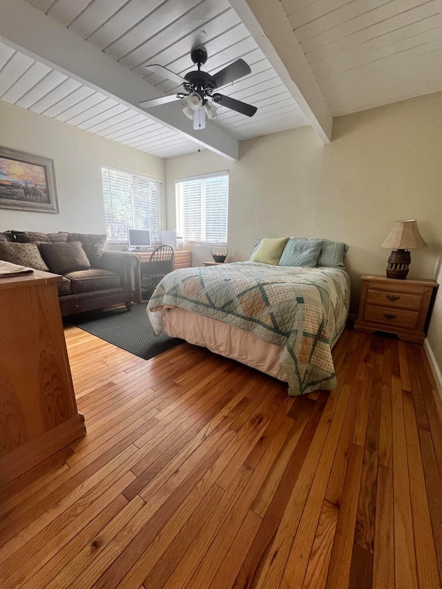 bedroom featuring beam ceiling, ceiling fan, and hardwood / wood-style floors