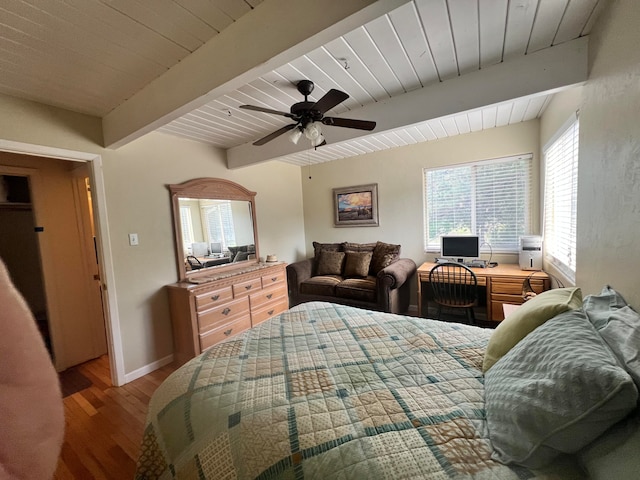 bedroom with beamed ceiling, ceiling fan, and hardwood / wood-style floors