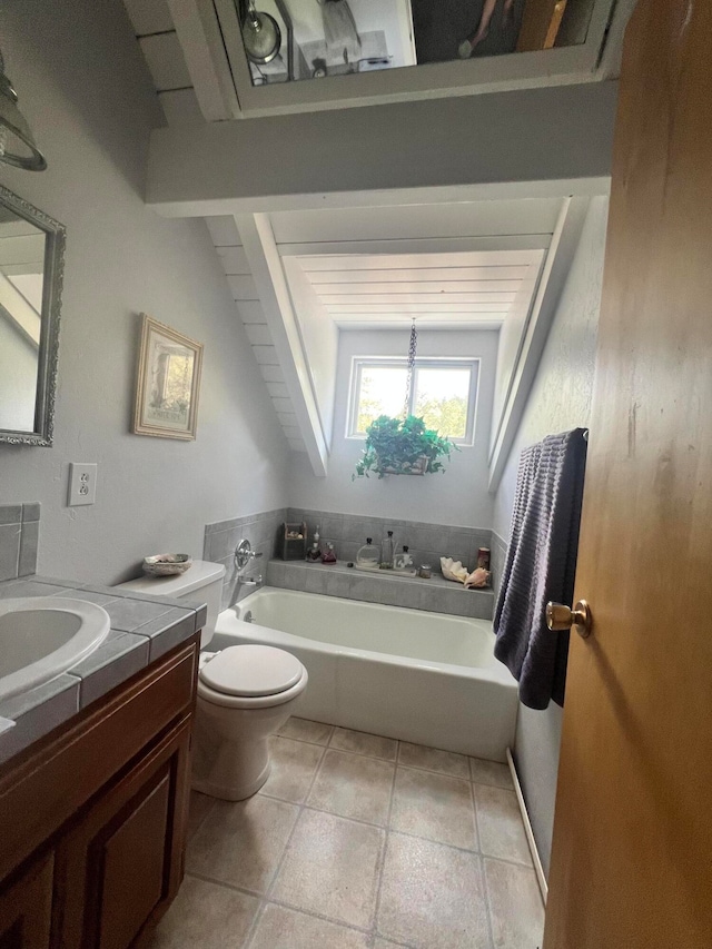 bathroom with tile patterned floors, vanity, a bath, and toilet