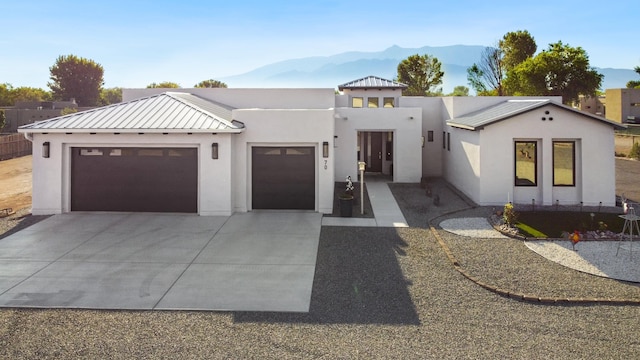 view of front facade featuring a garage and a mountain view