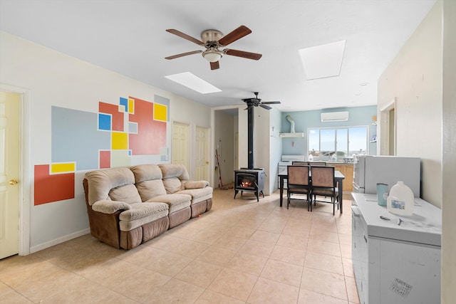 tiled living room with a wall unit AC, ceiling fan, and a wood stove