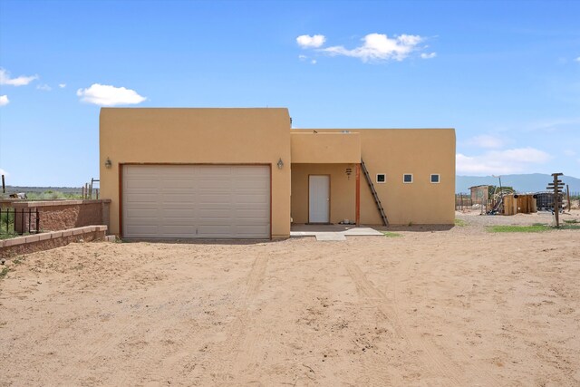 view of front facade with a playground and a garage