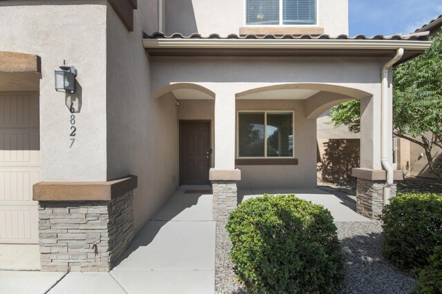 view of exterior entry with a garage