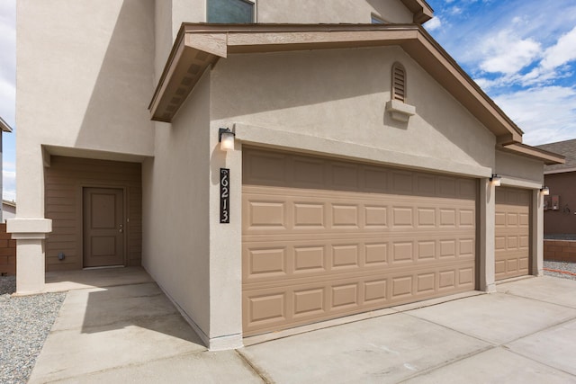 6213 White Hawk Dr NE, Rio Rancho, NM 87144 - view of front of house featuring stucco siding, driveway, and an attached garage
