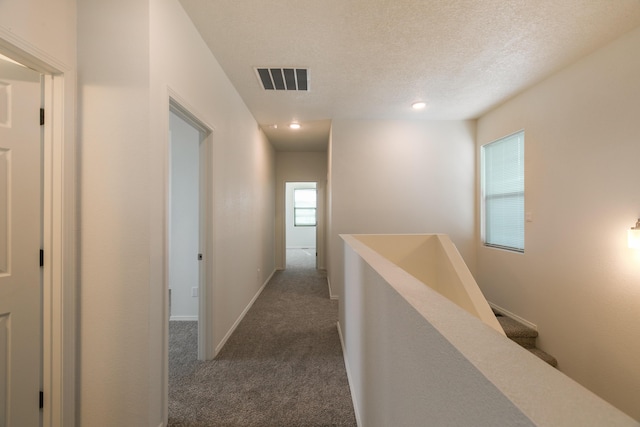 6213 White Hawk Dr NE, Rio Rancho, NM 87144 - hall featuring carpet flooring, a textured ceiling, an upstairs landing, and recessed lighting