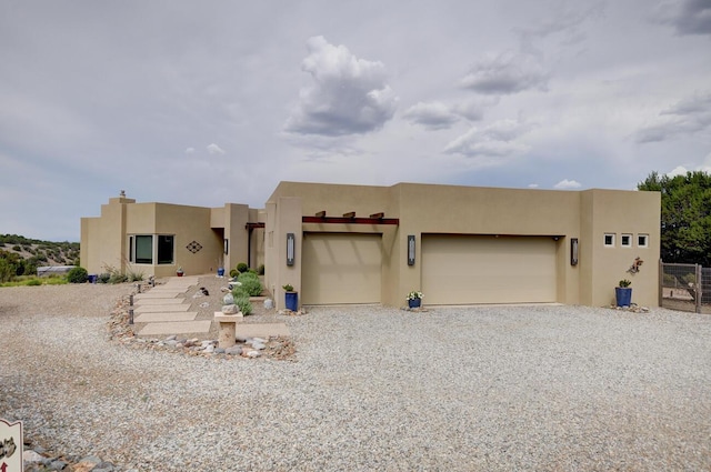 pueblo-style home featuring a garage