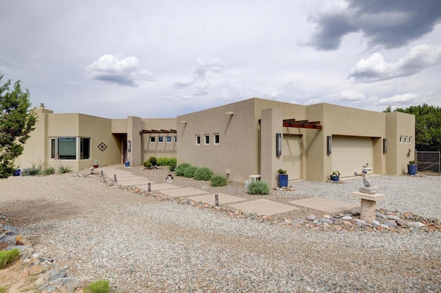 pueblo-style house with a garage