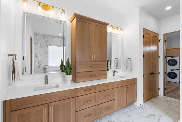 bathroom with vanity, wood-type flooring, and stacked washing maching and dryer