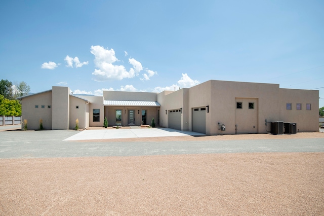 exterior space with a garage and cooling unit