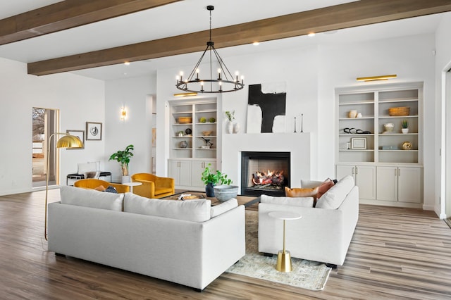 living room with beamed ceiling, a chandelier, and hardwood / wood-style flooring