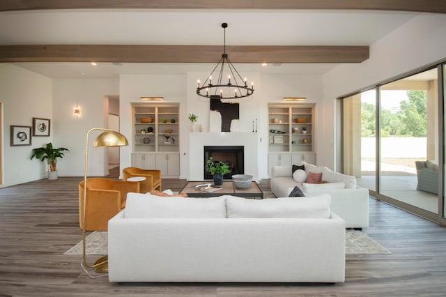 living room with dark wood-type flooring, beam ceiling, and an inviting chandelier