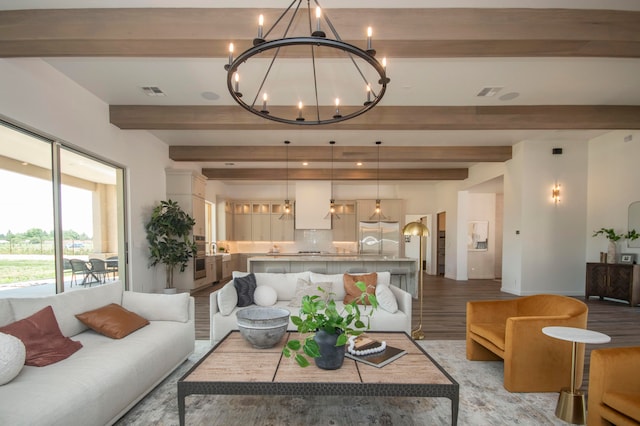 living room with beam ceiling, a notable chandelier, and light hardwood / wood-style flooring