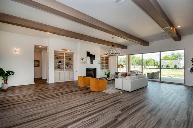 unfurnished living room with beamed ceiling, dark wood-type flooring, and a notable chandelier