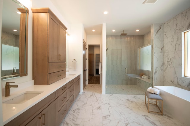 bathroom featuring vanity and shower with separate bathtub