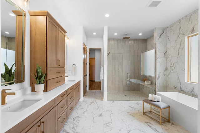 bathroom with vanity, independent shower and bath, and tile walls