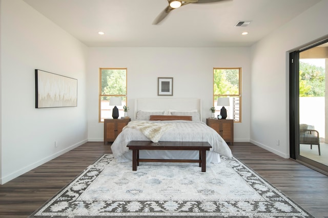 bedroom with dark hardwood / wood-style floors and ceiling fan