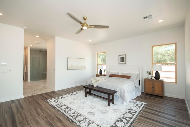 bedroom with ceiling fan and dark hardwood / wood-style flooring