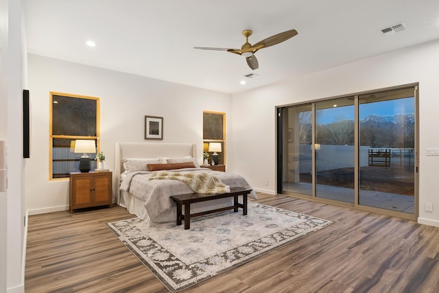 bedroom featuring hardwood / wood-style flooring, access to outside, and ceiling fan