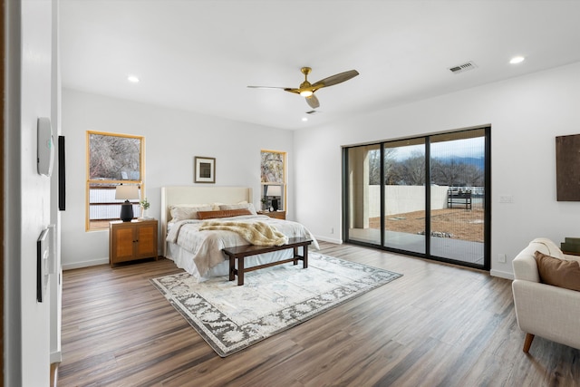 bedroom with hardwood / wood-style floors, access to exterior, and ceiling fan