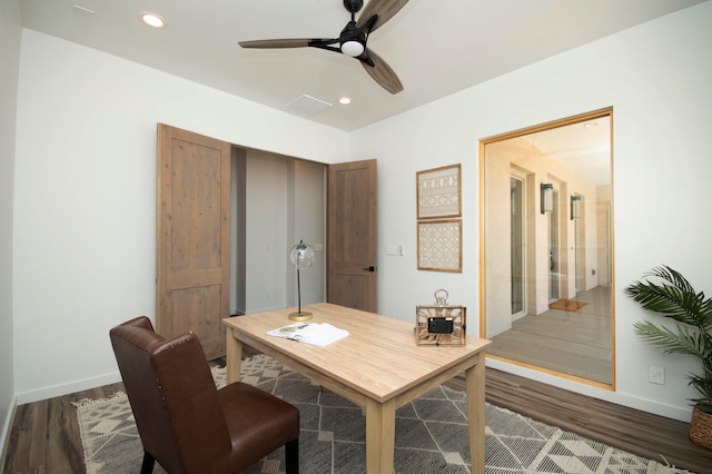 office area with ceiling fan and dark hardwood / wood-style flooring