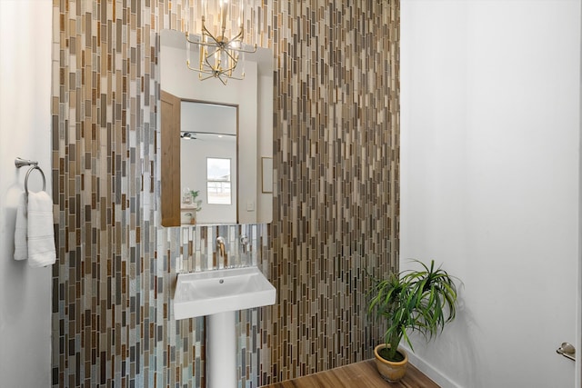 bathroom with hardwood / wood-style flooring, sink, and tile walls