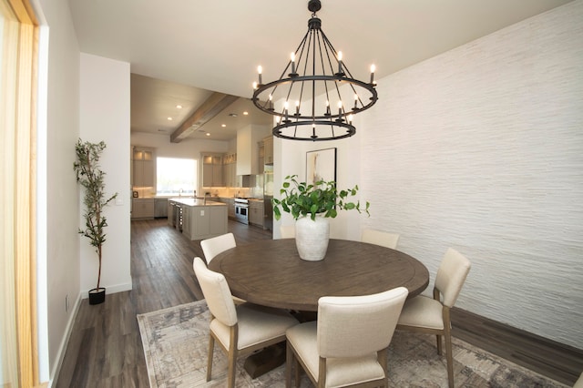 dining space featuring an inviting chandelier, beamed ceiling, and dark wood-type flooring