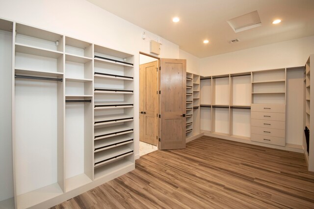 walk in closet with hardwood / wood-style floors